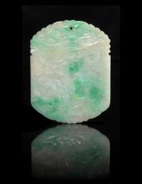 A Carved Jadeite Pendant. Length 2 inches.