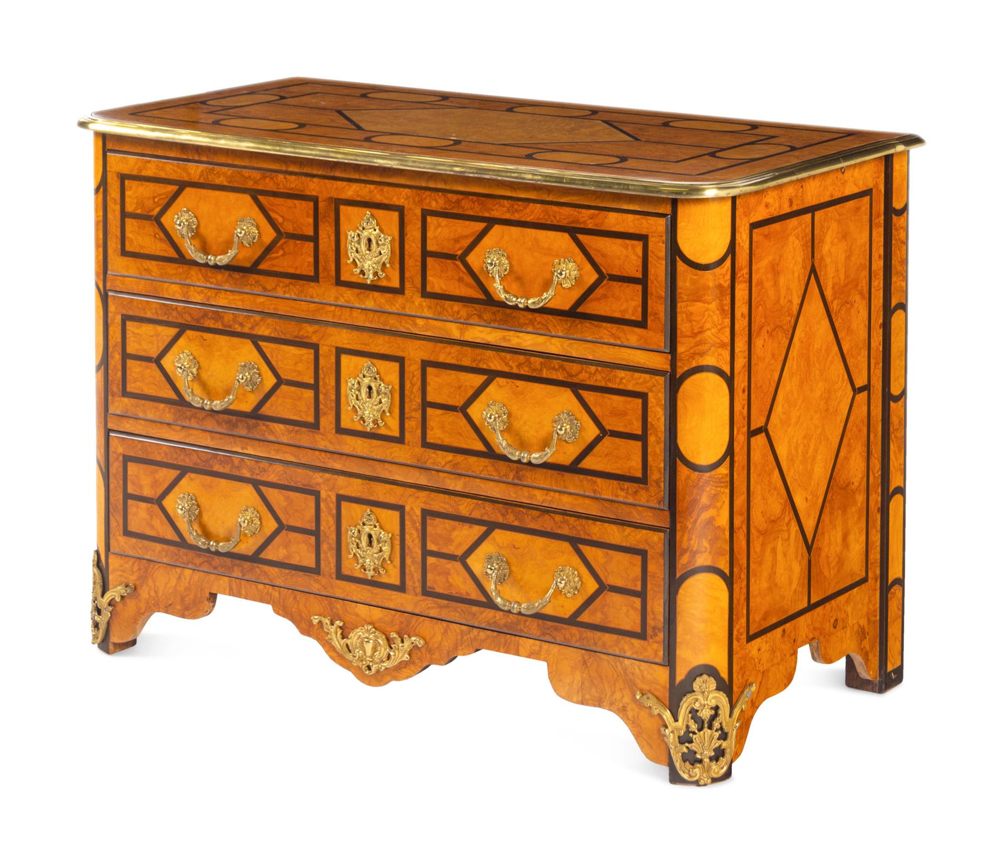 A Régence Style Gilt Metal Mounted Burl Walnut Chest of Drawers