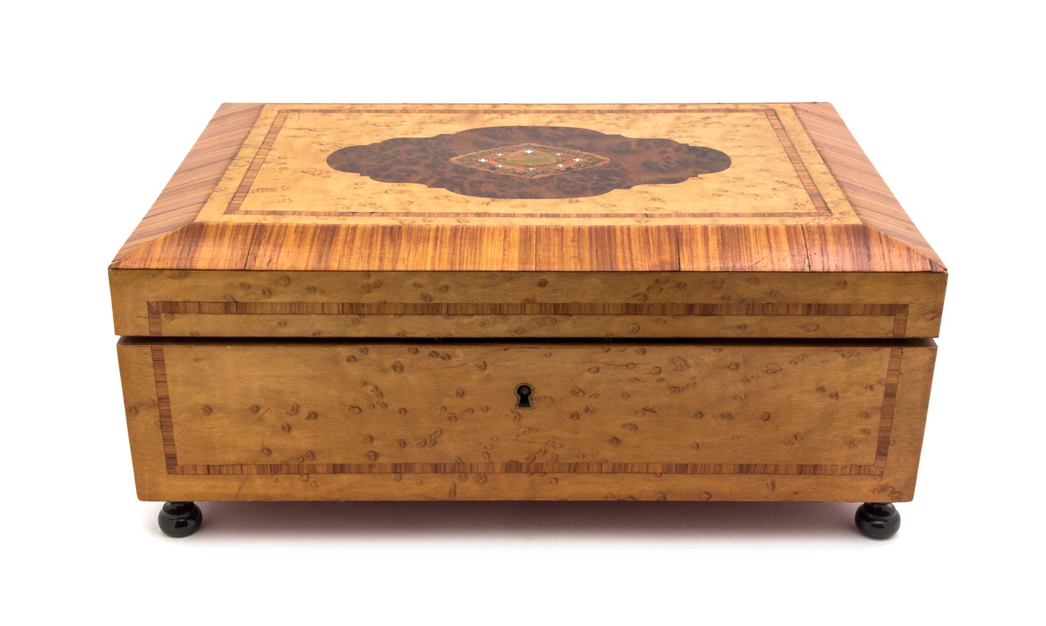A Continental Mother-of-Pearl and Brass Inlaid Various Woods Musical Dresser Box, Width 13 1/2 inches.