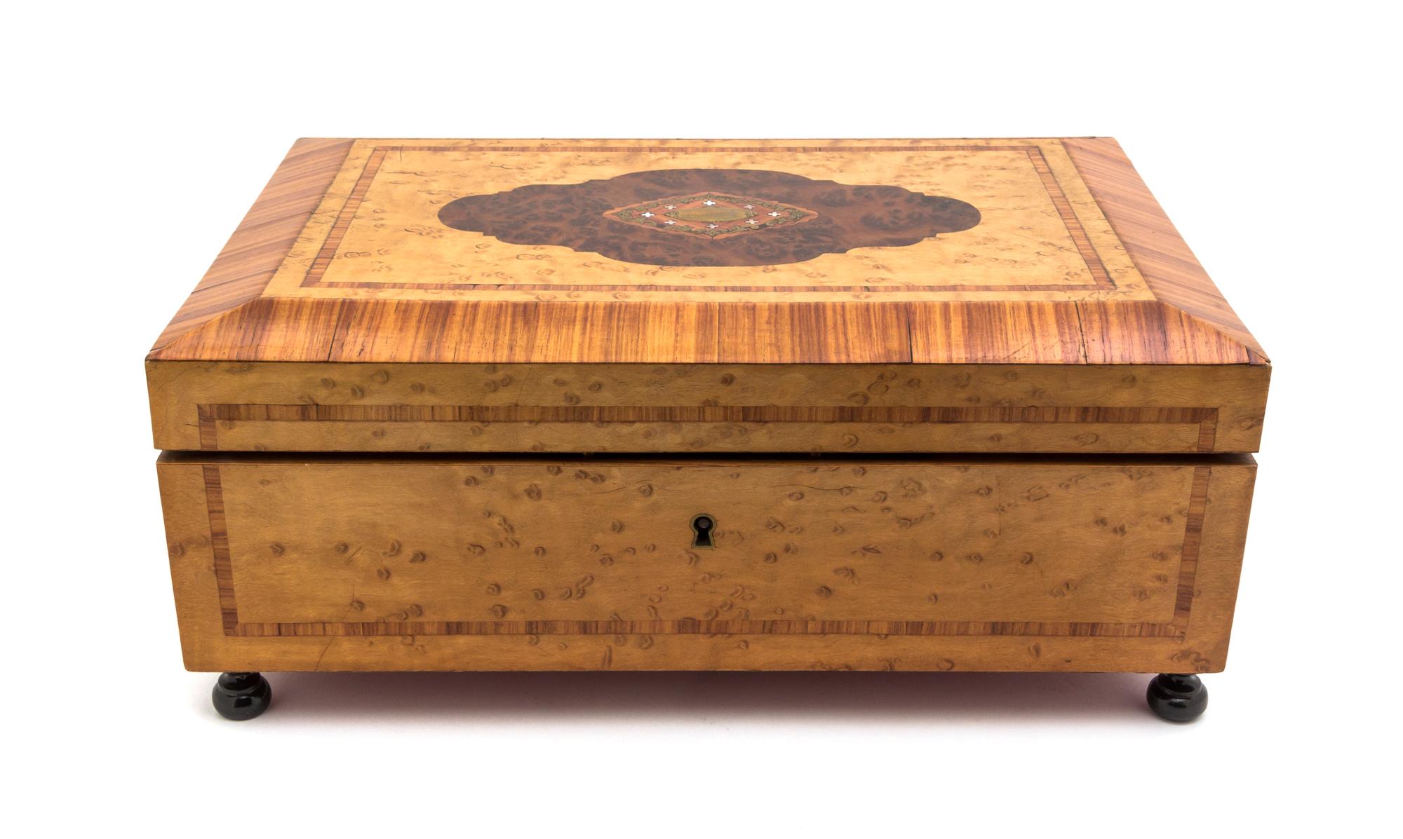A Continental Mother-of-Pearl and Brass Inlaid Various Woods Musical Dresser Box, Width 13 1/2 inches.