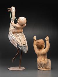 A Folk Art Carved and Painted Wood Figural Group of a Stork and Two Babies