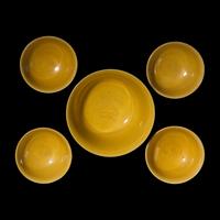 A Group of Five Chinese Incised Yellow Glazed Porcelain "Dragon" Bowls, 19th/20th Century — 清晚期 黃釉暗刻龍紋碗一組五件