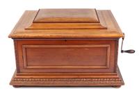 A Regina 15 1/2-Inch Double-Comb Disk Oak Music Box