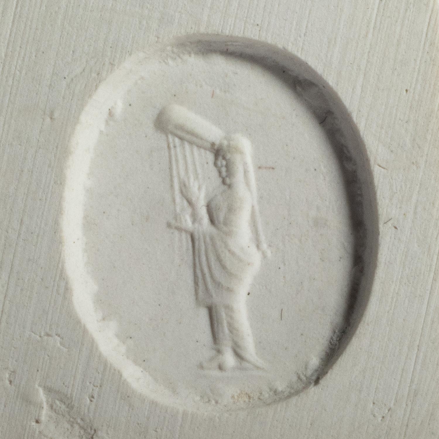 A Greco-Persian Pale Blue Chalcedony Scaraboid with a Muse Playing a Lyre