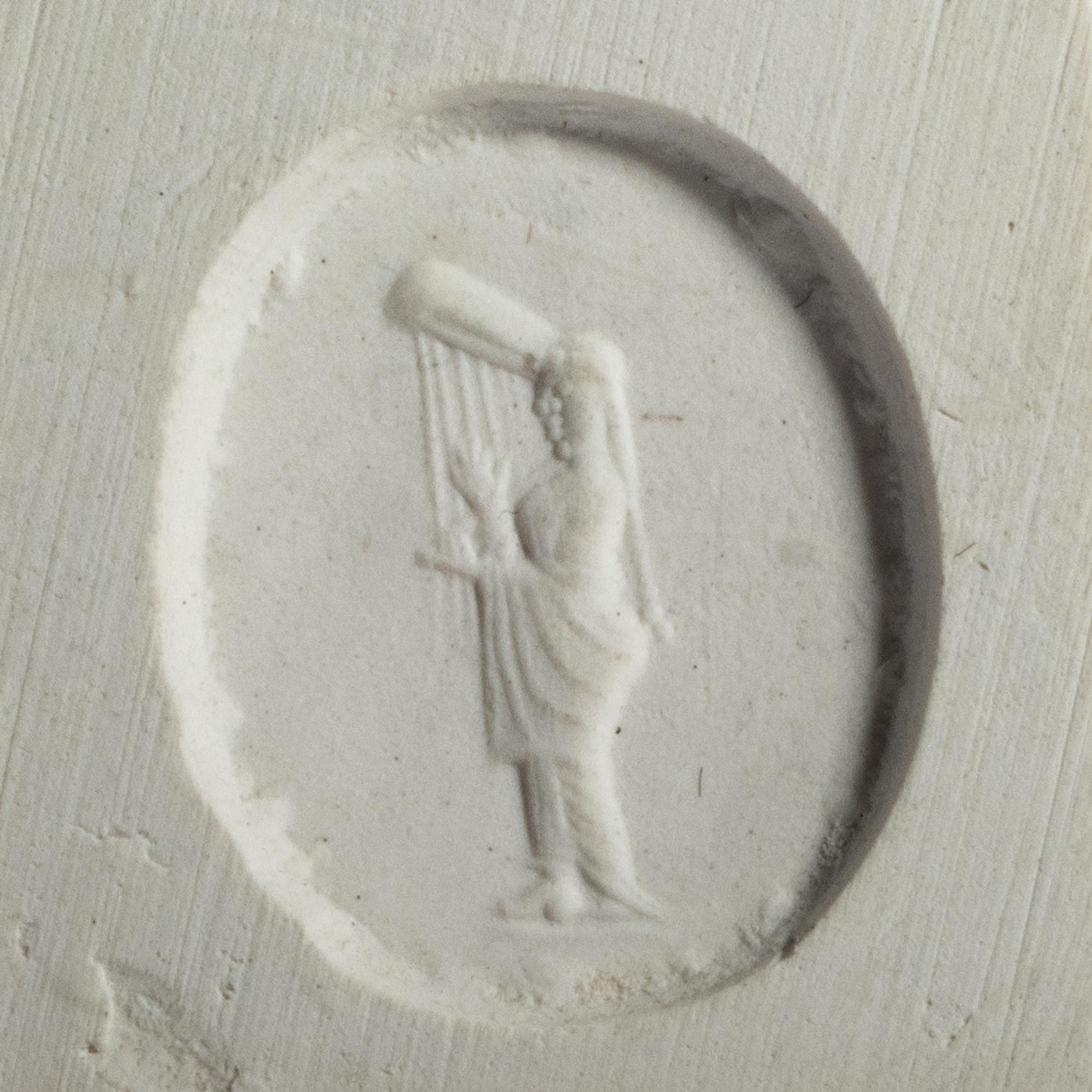 A Greco-Persian Pale Blue Chalcedony Scaraboid with a Muse Playing a Lyre