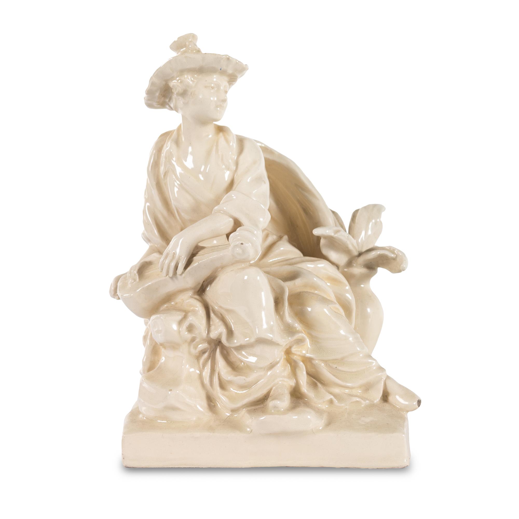 A French White Glazed Faience Chinoiserie Figure