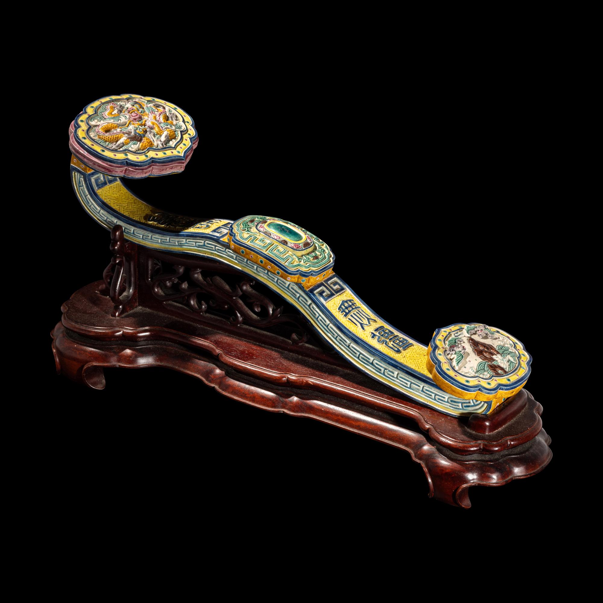 A Chinese Molded Famille Rose Porcelain Ruyi Scepter 粉彩瓷如意配木座