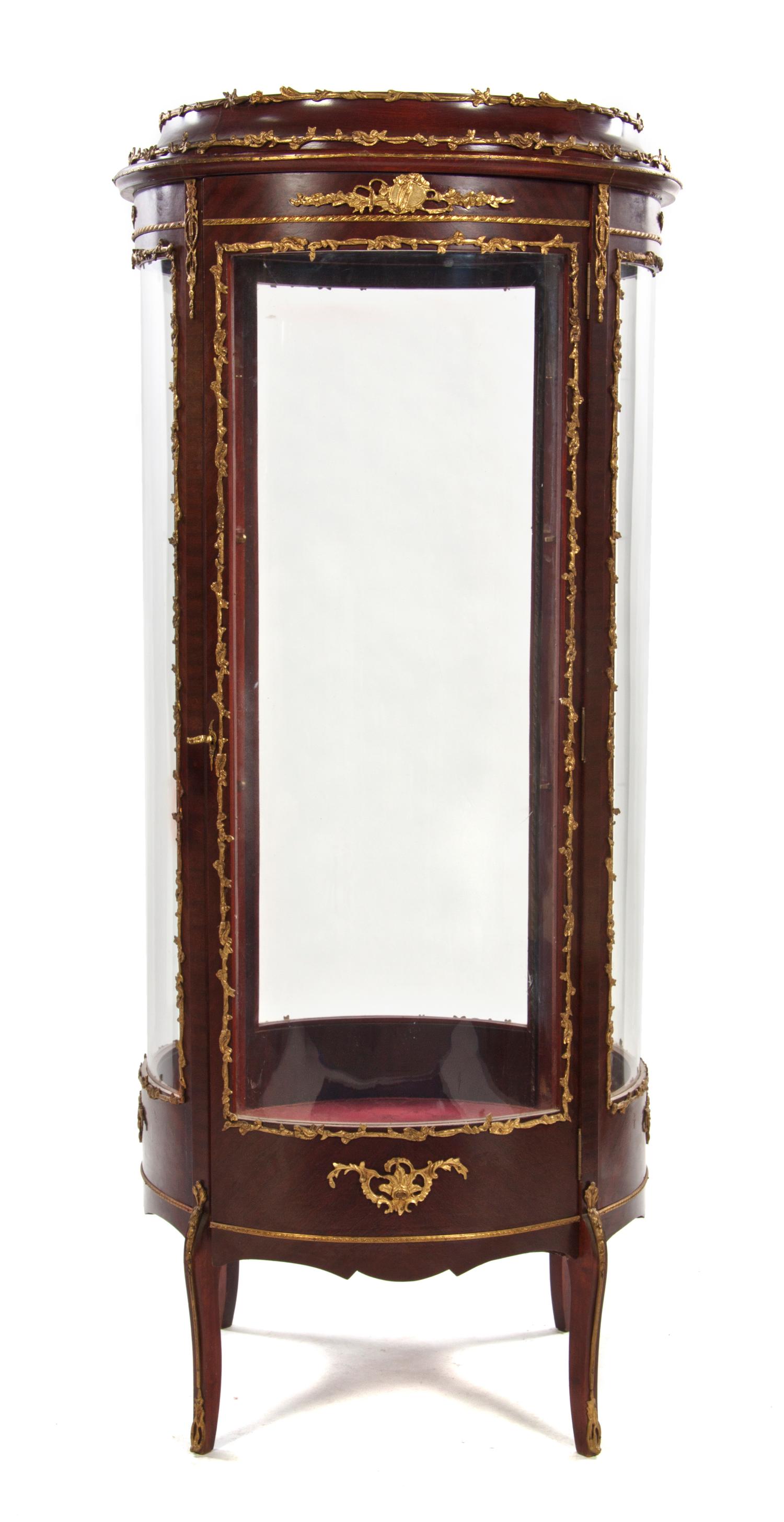 A Louis XVI Style Gilt Bronze Mounted Mahogany Vitrine, Height 64 1/2 x diameter 27 inches.