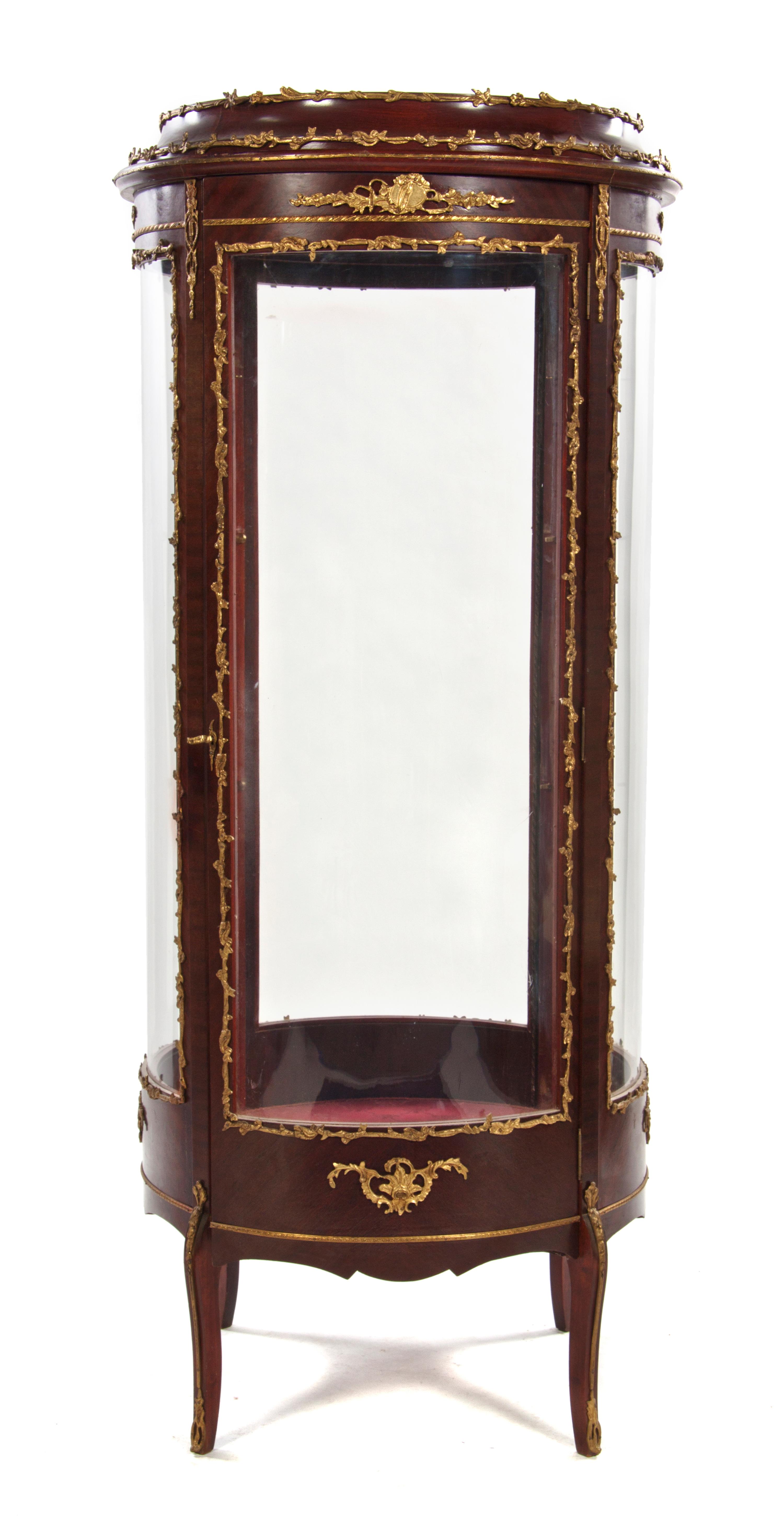 A Louis XVI Style Gilt Bronze Mounted Mahogany Vitrine, Height 64 1/2 x diameter 27 inches.