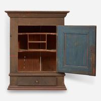 A green or brown painted pine wall cupboard late 18th century