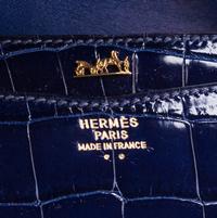An Hermes Navy Niloticus Crocodile Faco Clutch, 9.25" x 7" x 1".