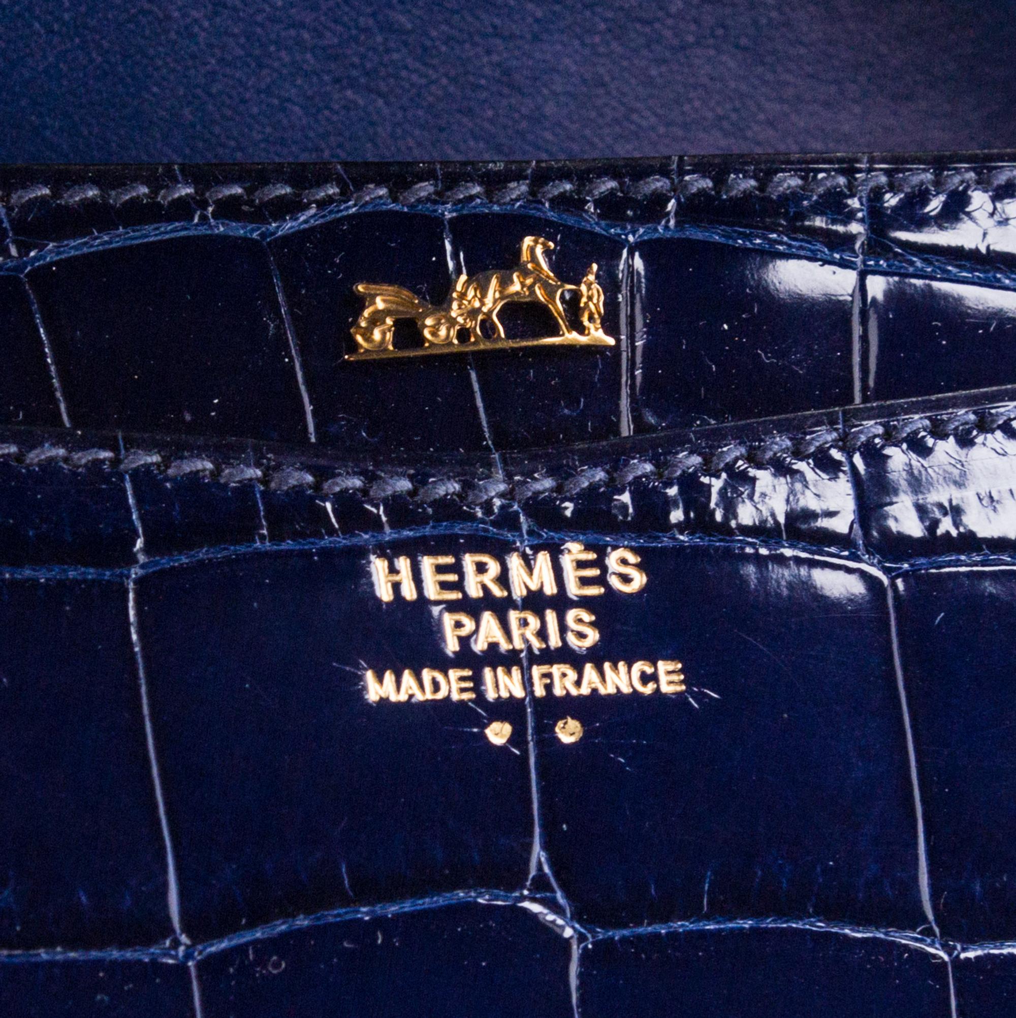 An Hermes Navy Niloticus Crocodile Faco Clutch, 9.25" x 7" x 1".