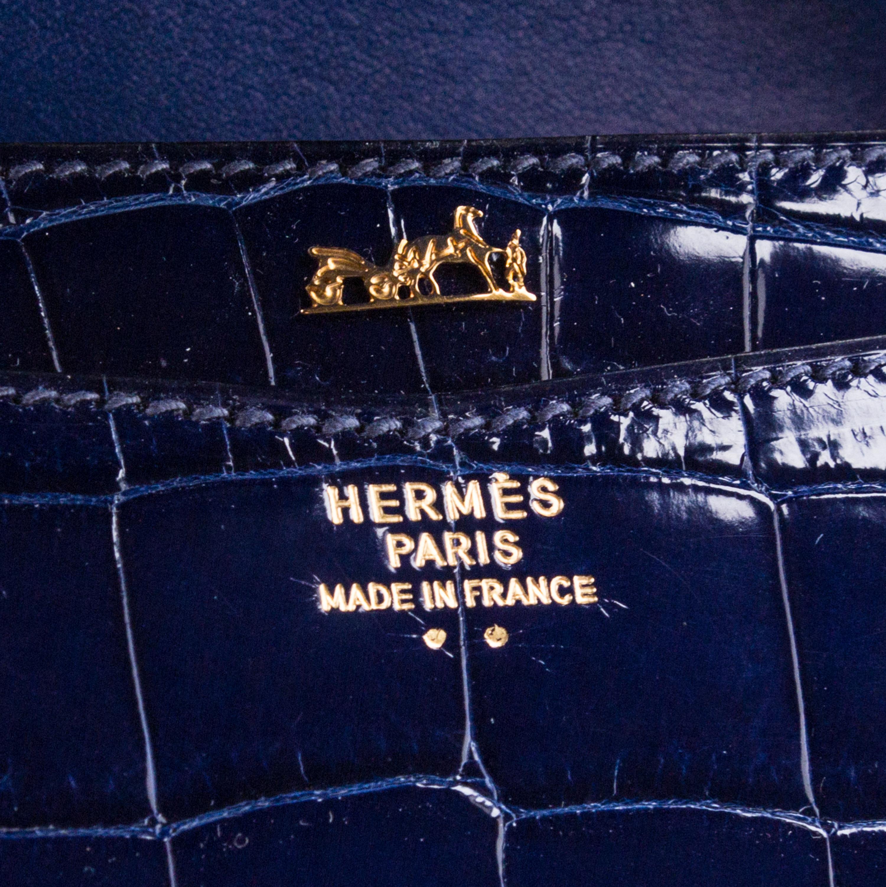 An Hermes Navy Niloticus Crocodile Faco Clutch, 9.25" x 7" x 1".