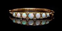 A Yellow Gold, Opal and Diamond Bangle Bracelet, 9.10 dwts.