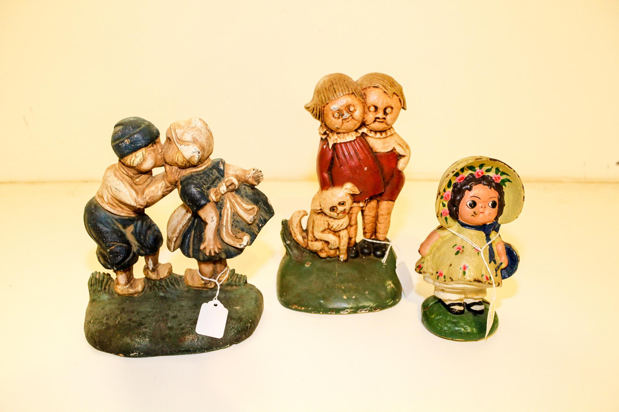 A Group of Painted Cast Iron Doorstops Height of tallest 9 3/4 inches.
