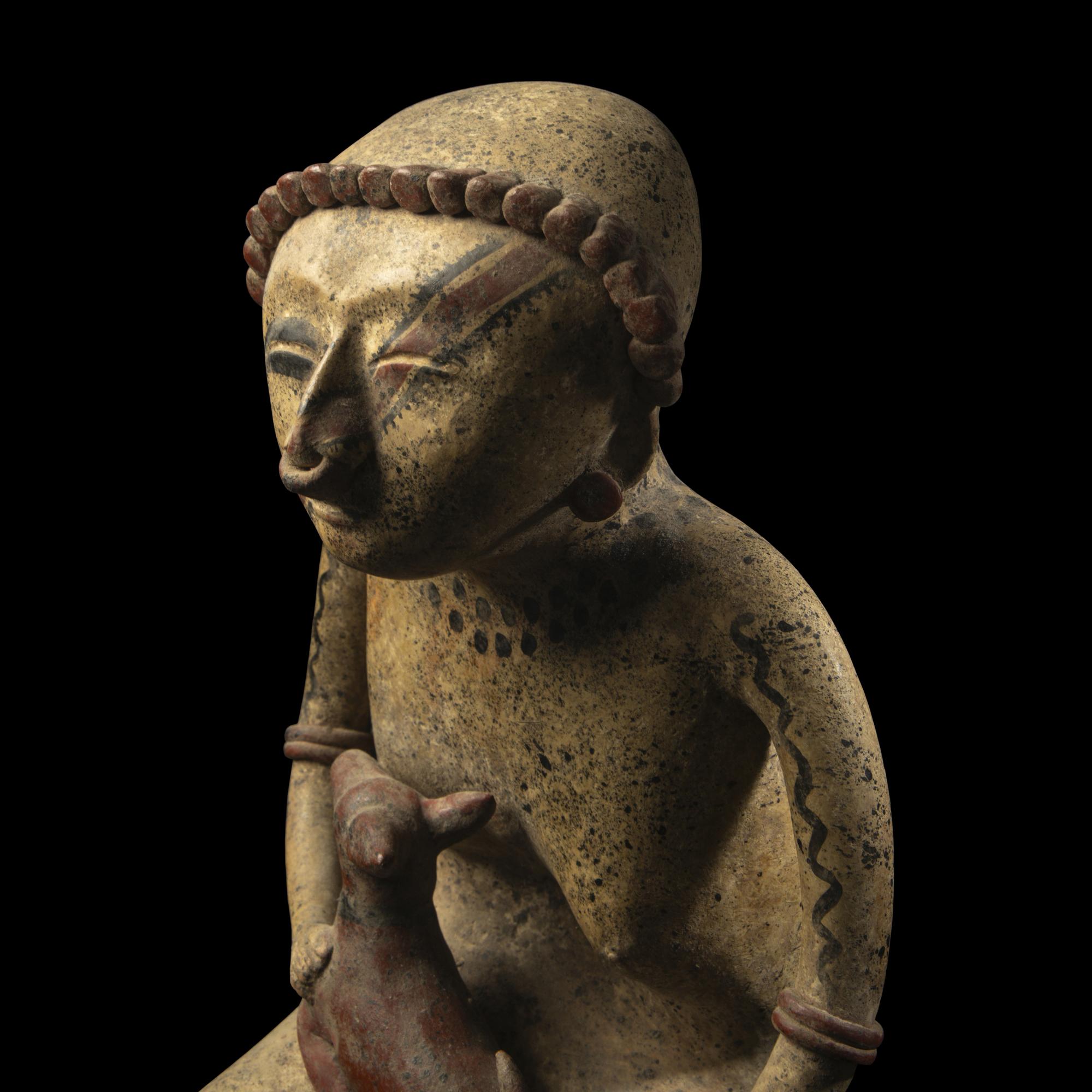 A Nayarit Terracotta Seated Figure with Dog