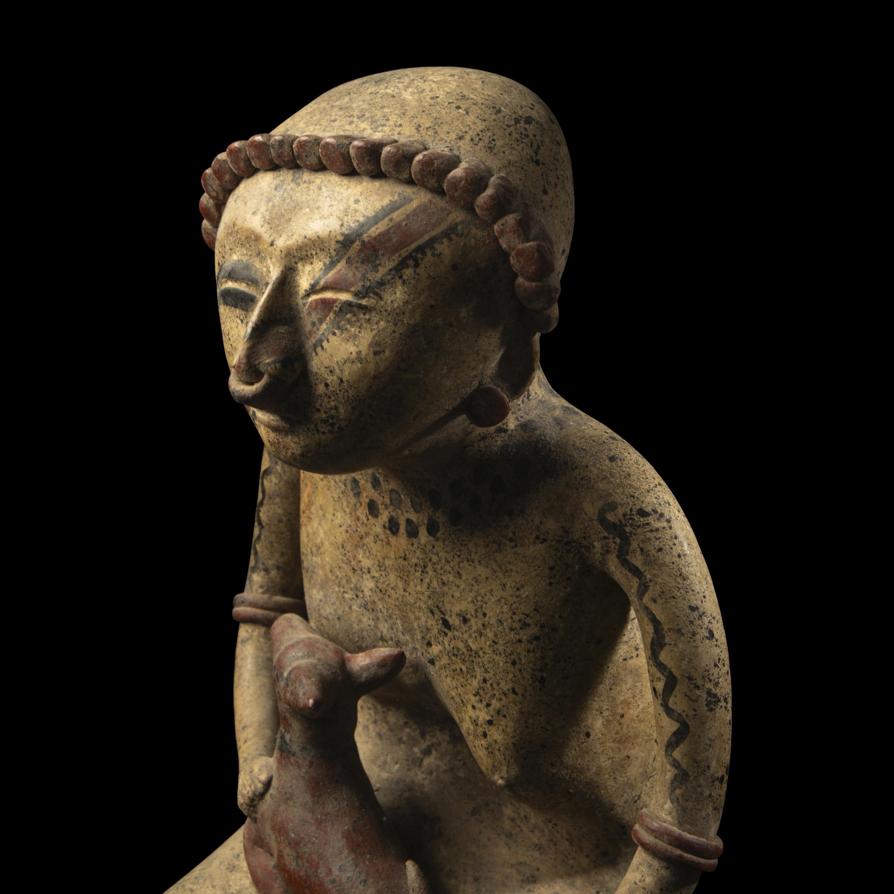 A Nayarit Terracotta Seated Figure with Dog