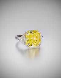 A Fine Platinum, Fancy Intense Yellow Diamond and Diamond Ring, 7.40 dwts.