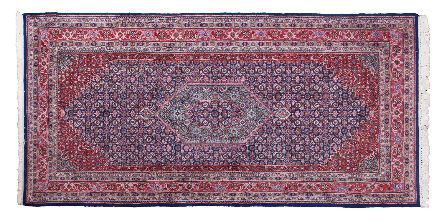 An Iranian Rug 9 feet 7 inches x 4 feet 10 1/2 inches.