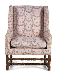 A Louis XIII Style Carved Armchair and Ottoman