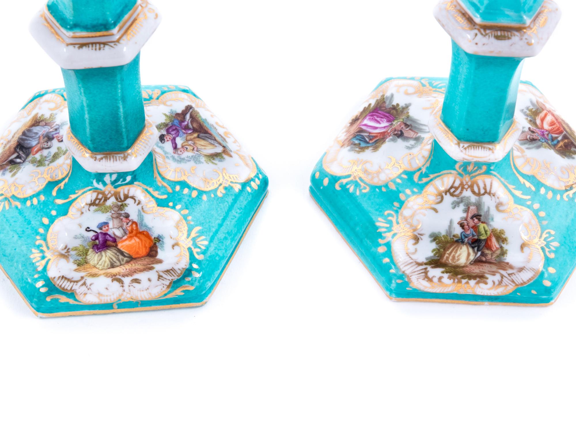 A Pair of Berlin (K.P.M.) Painted and Parcel Gilt Porcelain Candlesticks