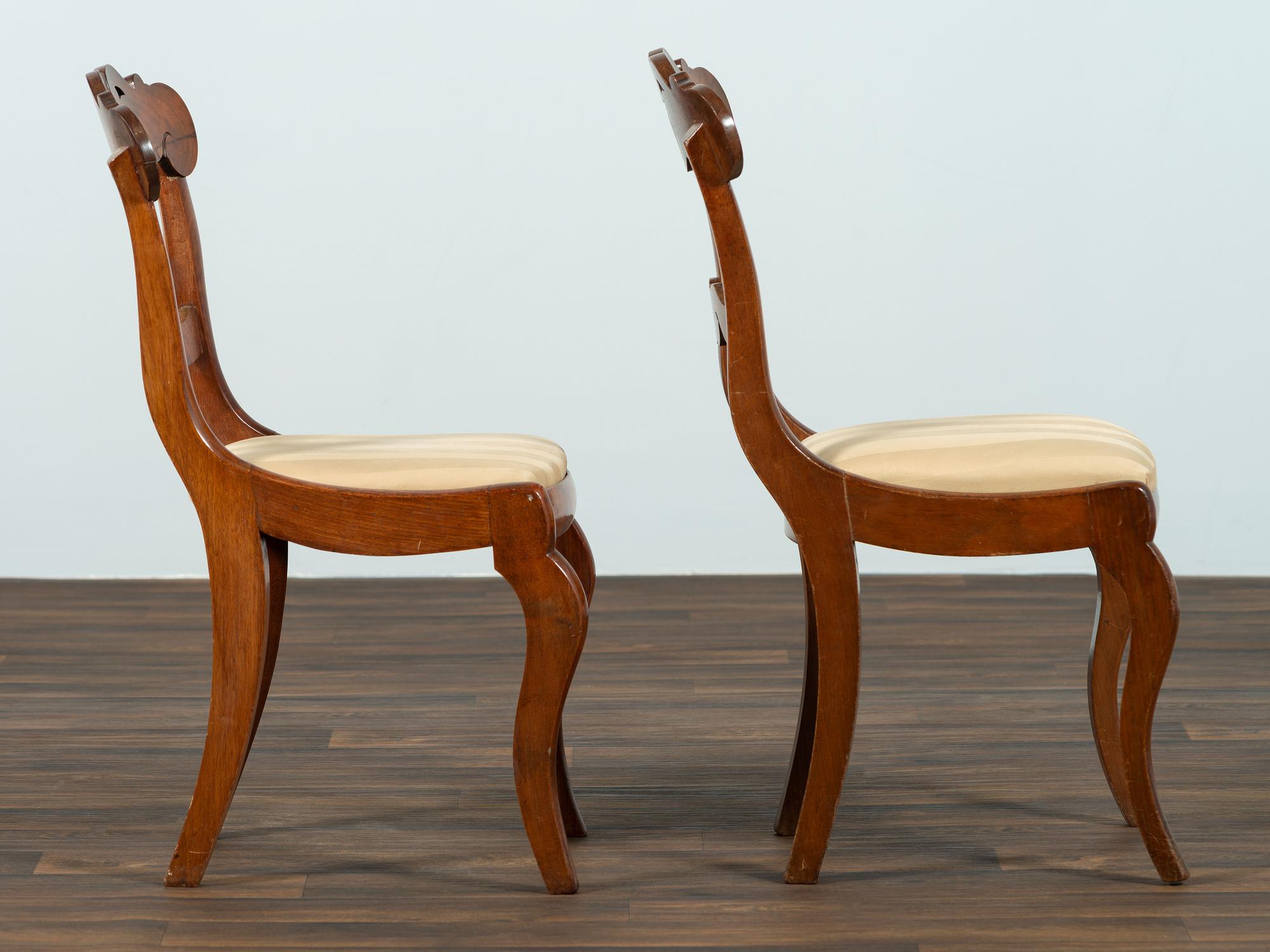 A Set of Six Classical Carved Walnut Dining Chairs