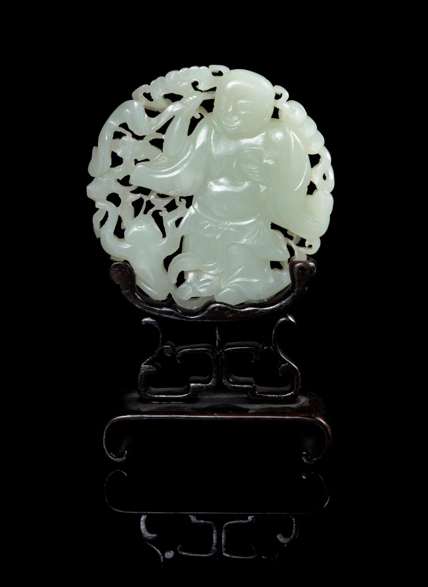 A Carved Celadon Jade Circular Plaque Diameter 3 1/4 inches. — 19TH CENTURY