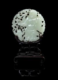 A Carved Celadon Jade Circular Plaque Diameter 3 1/4 inches. — 19TH CENTURY