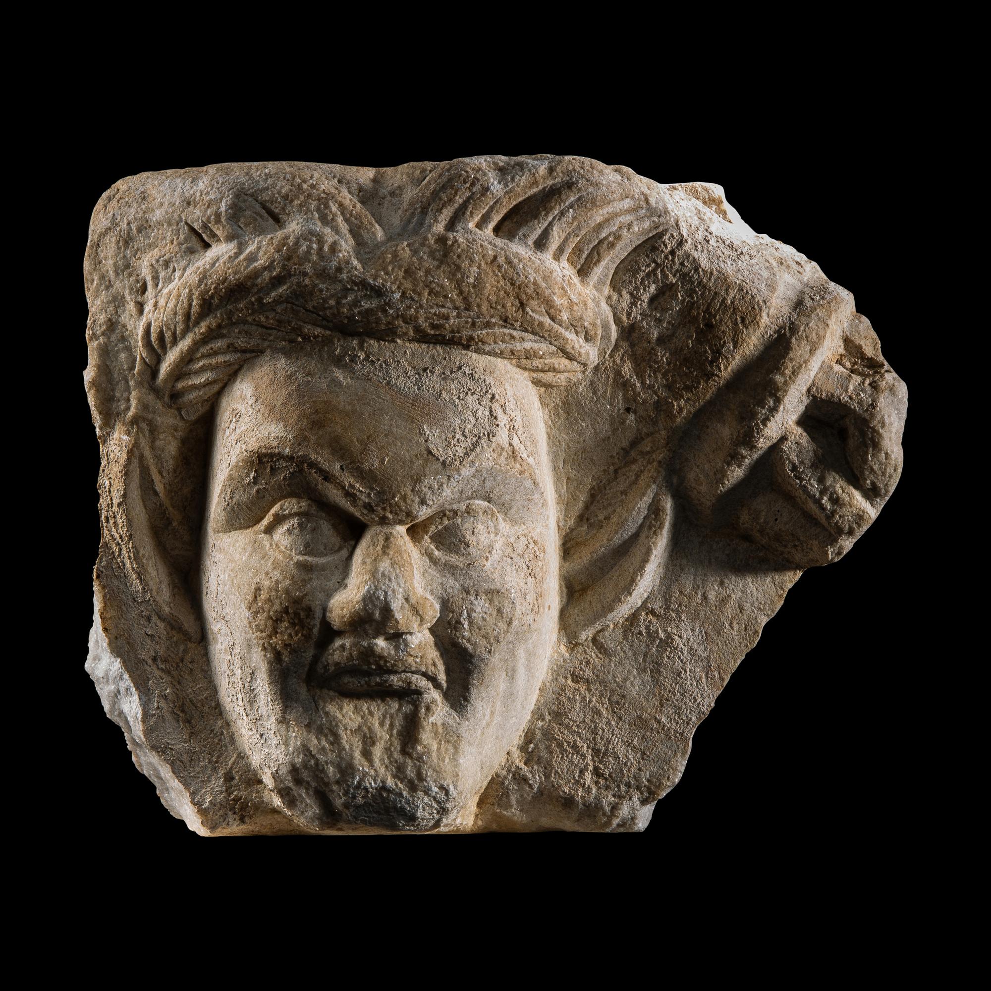 A Roman Marble Relief Fragment with the Head of a Satyr