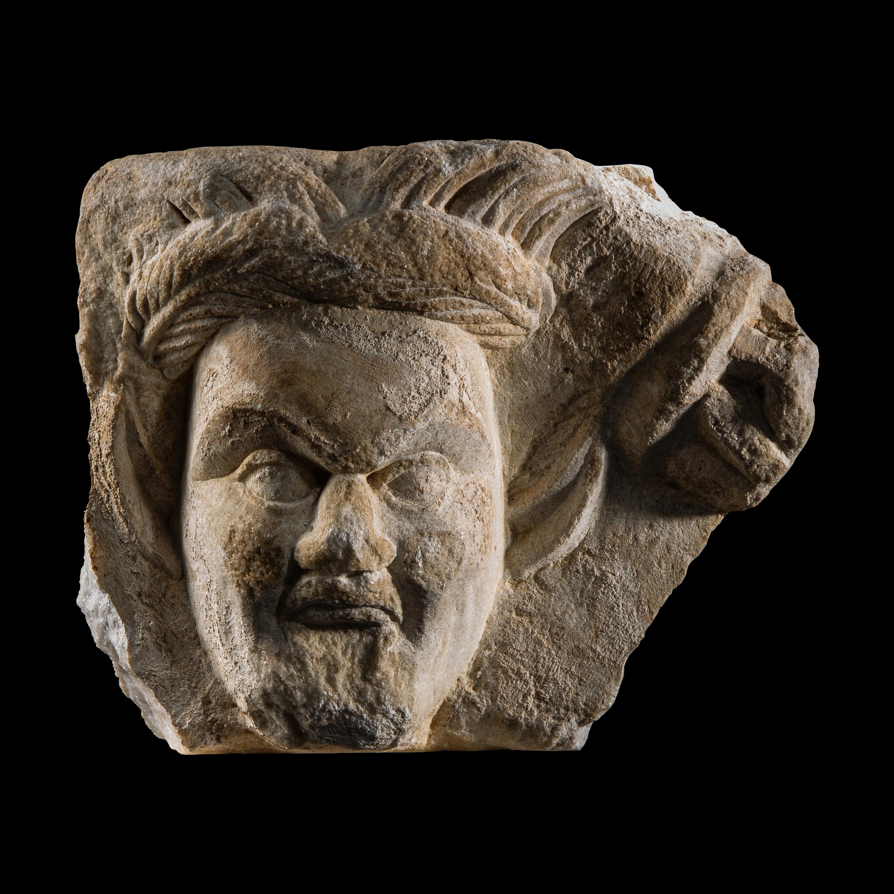 A Roman Marble Relief Fragment with the Head of a Satyr