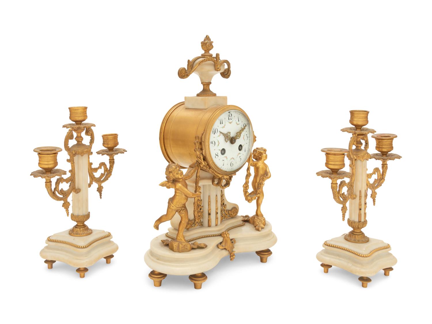 A Louis XVI Style Gilt Bronze and Marble Clock Garniture