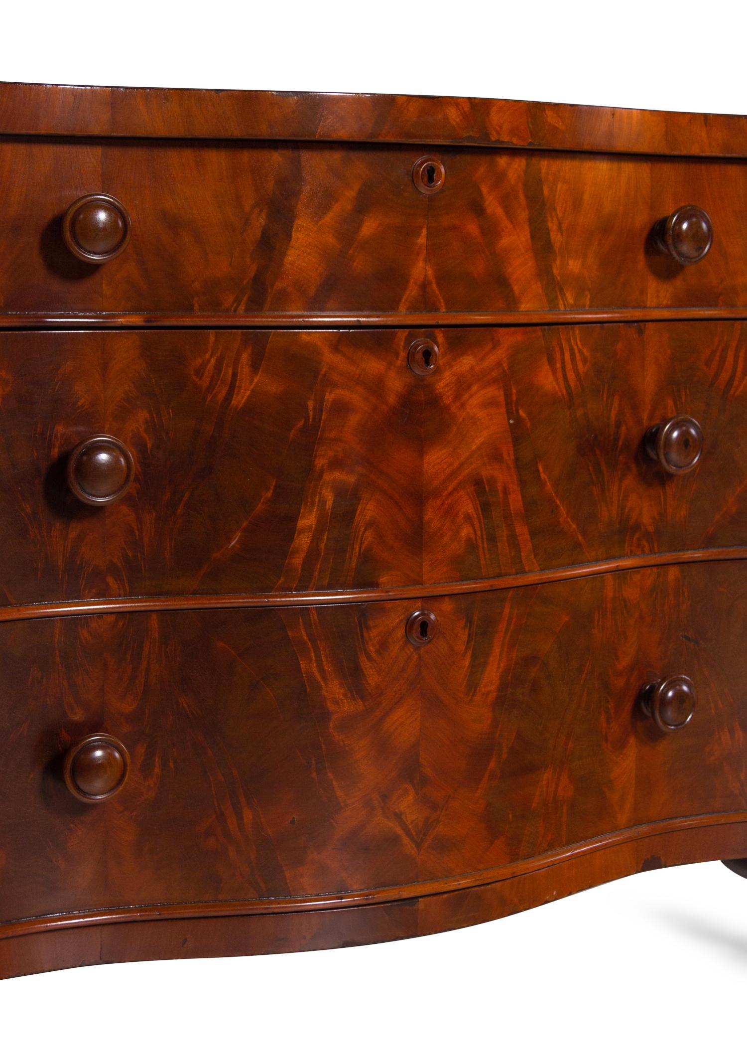 A Continental Walnut Serpentine-Front Chest of Drawers