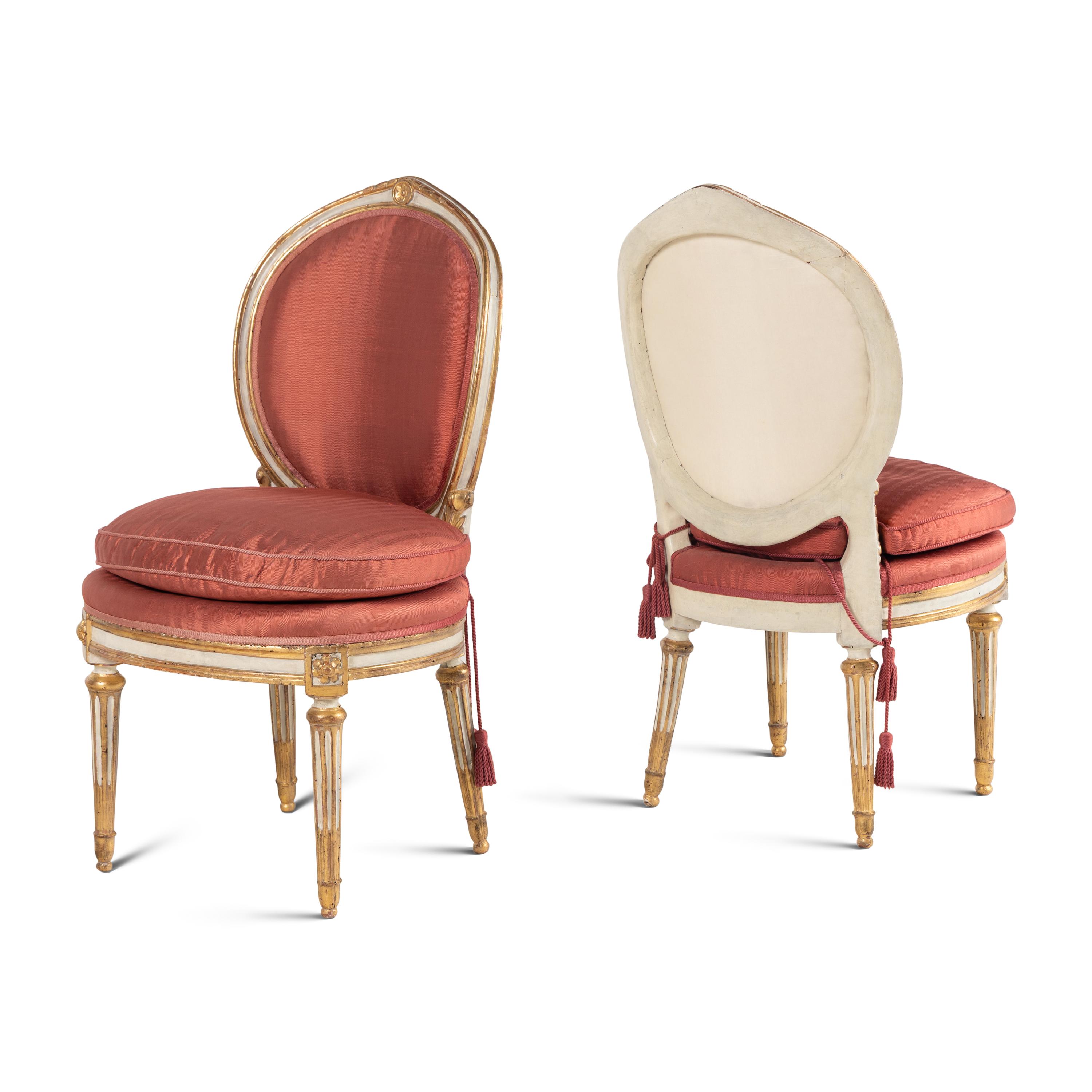 A Set of Four Italian Neoclassical Crème-Painted and Parcel Gilt Side Chairs