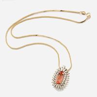 A topaz, diamond, and gold pendant