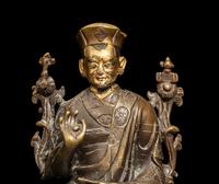 A Tibetan Parcel Gilt Bronze Figure of a Seated Lama