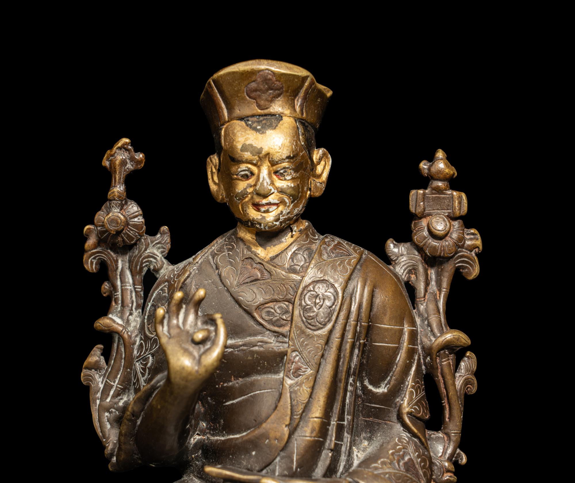 A Tibetan Parcel Gilt Bronze Figure of a Seated Lama