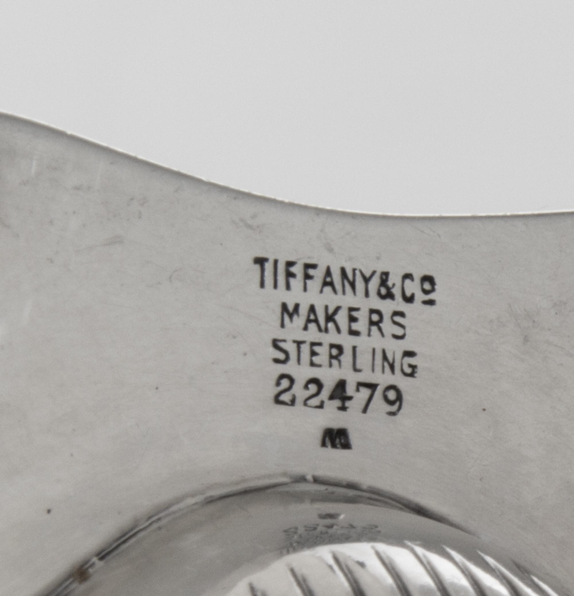 A Pair of American Silver Ash Receivers, Tiffany & Co., New York, NY, 1937, each of shell form with two feet.