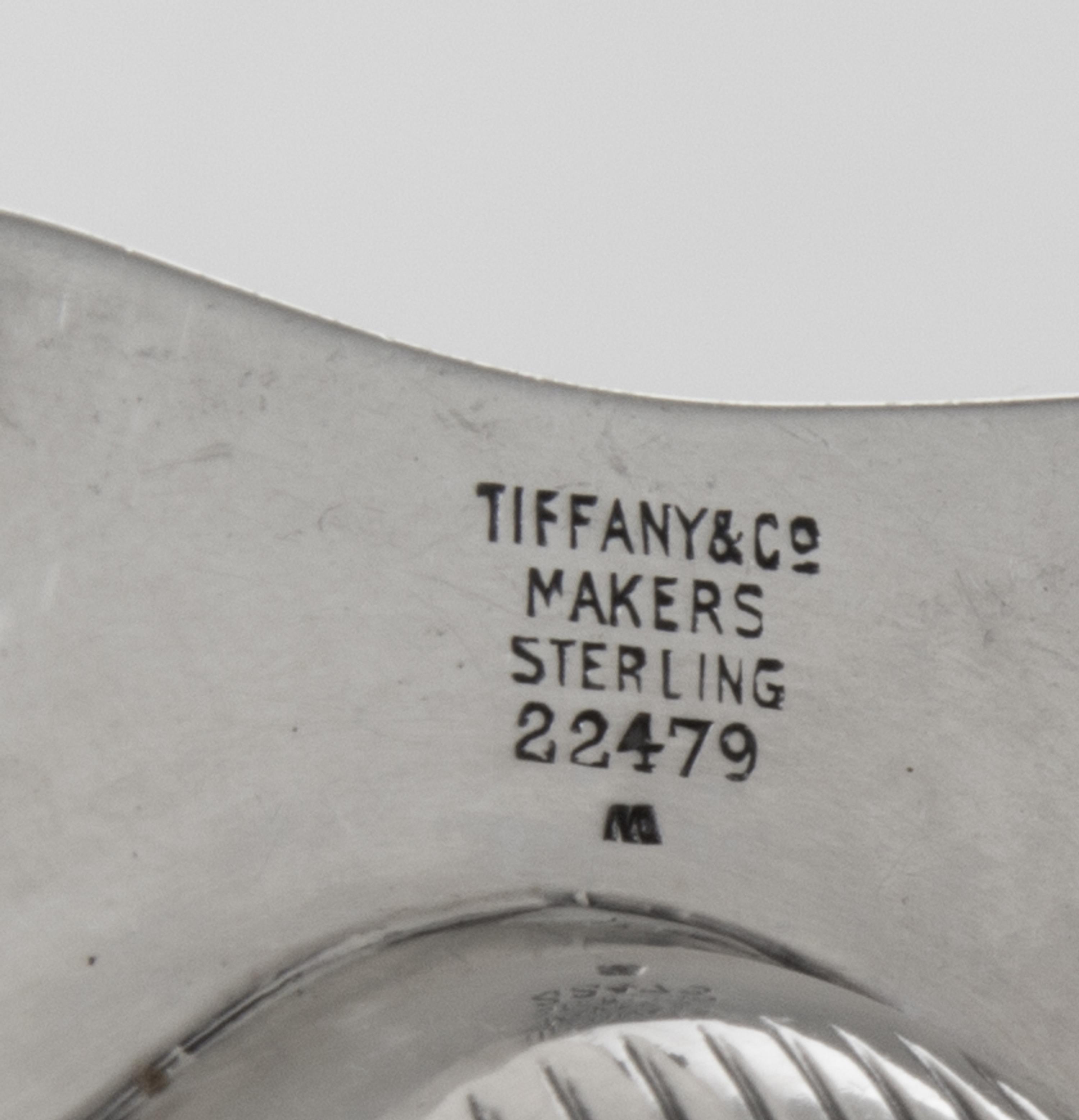 A Pair of American Silver Ash Receivers, Tiffany & Co., New York, NY, 1937, each of shell form with two feet.