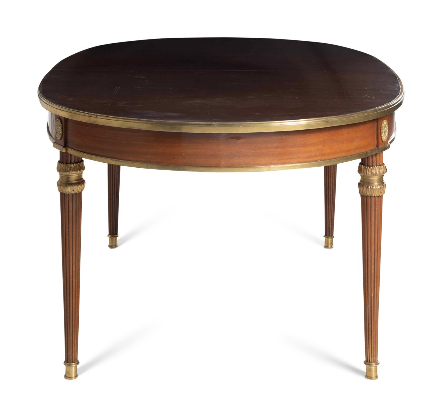 A Louis XVI Style Gilt Bronze Mounted Mahogany Dining Table