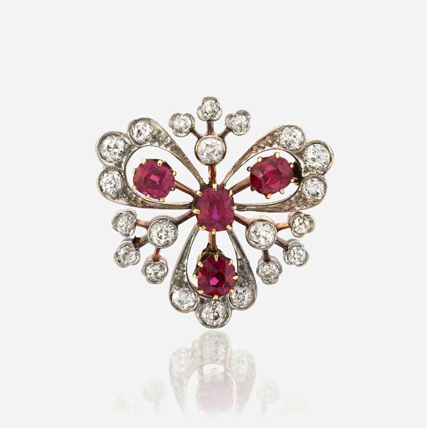 A ruby, diamond, and platinum topped gold pendant/brooch