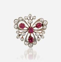 A ruby, diamond, and platinum topped gold pendant/brooch