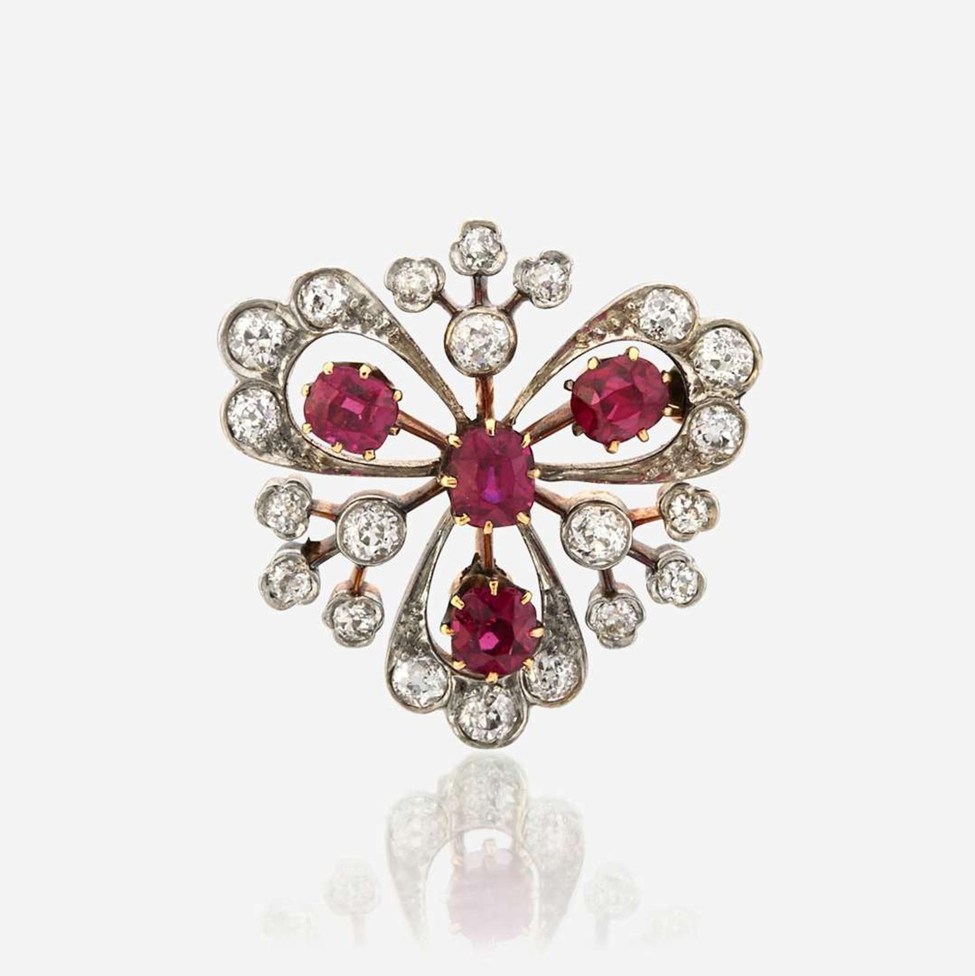 A ruby, diamond, and platinum topped gold pendant/brooch