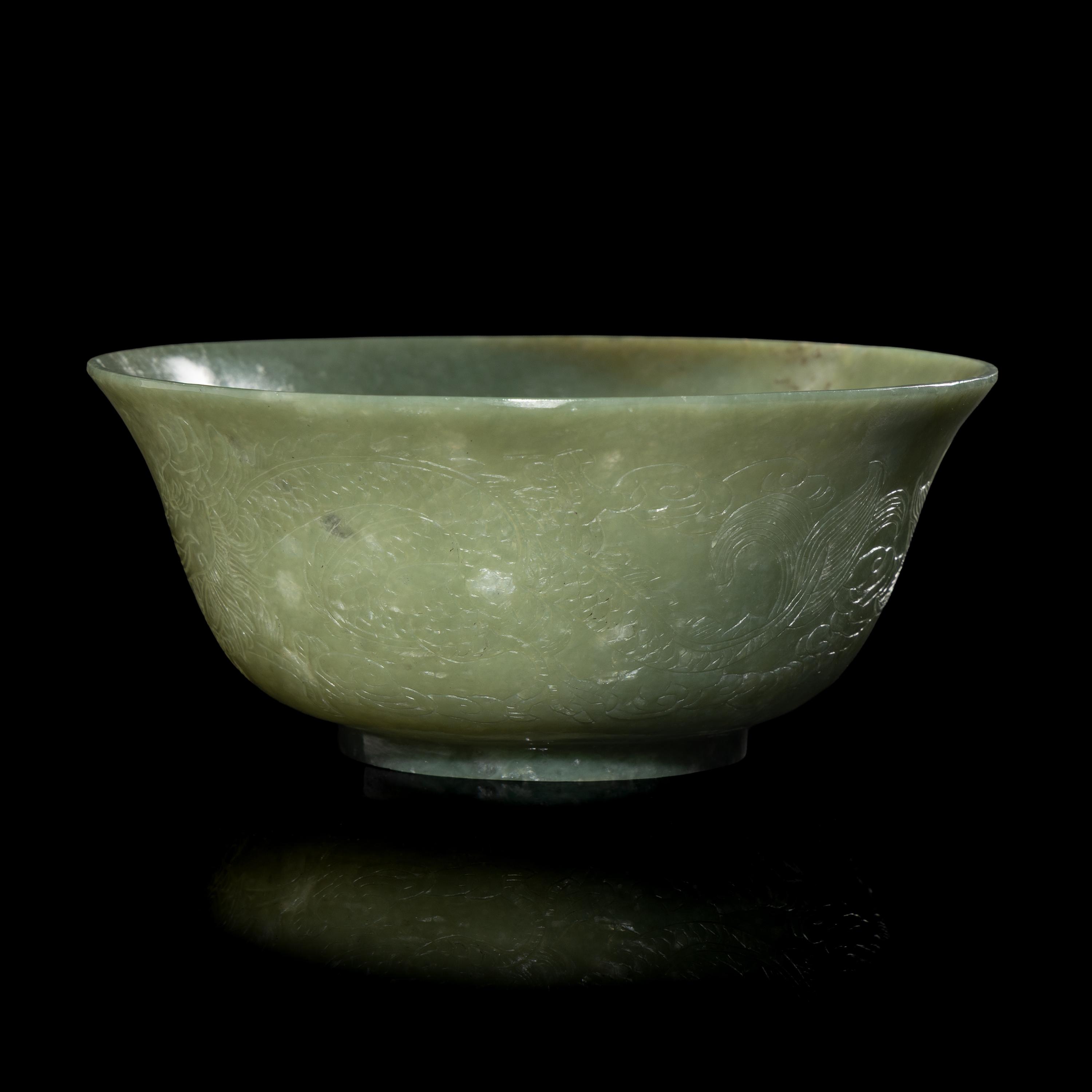 A Chinese Celadon Jade 'Dragon' Bowl, 20th Century 近代 青玉刻龍紋碗