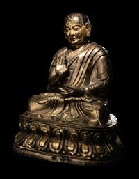 A Large Tibetan Parcel Gilt Bronze Repoussé Figure of a Seated Monk