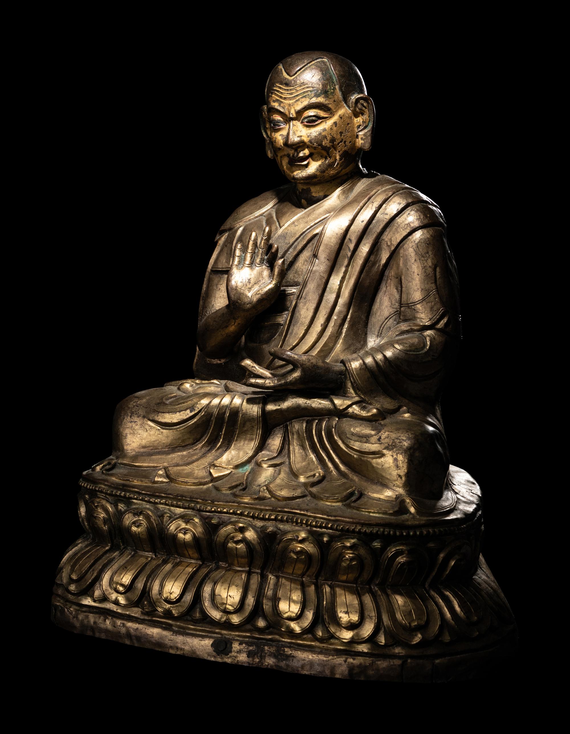 A Large Tibetan Parcel Gilt Bronze Repoussé Figure of a Seated Monk