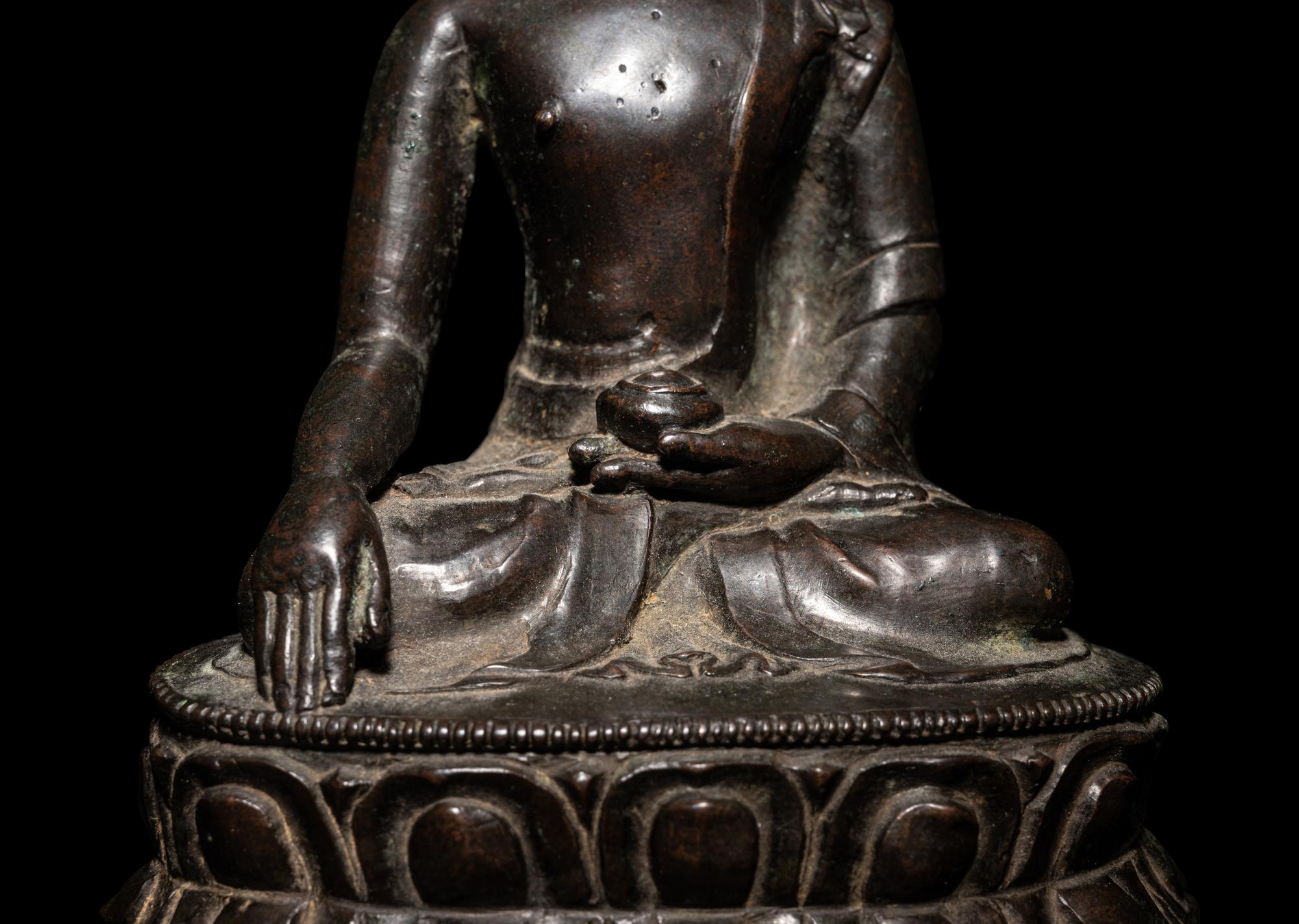 A Tibetan Bronze Figure of Seated Buddha Akshobhya