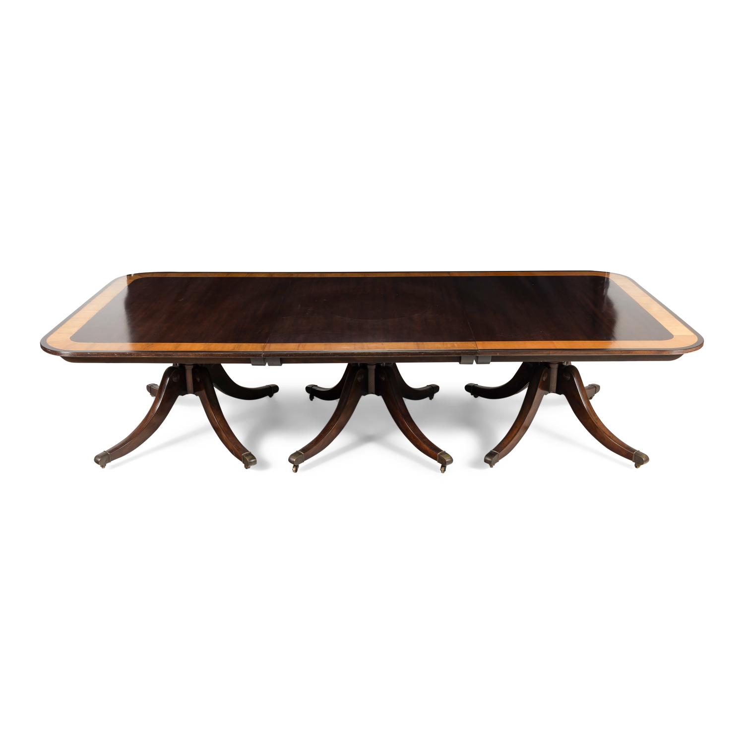 A Regency Style Mahogany and Satinwood Three-Pedestal Dining Table