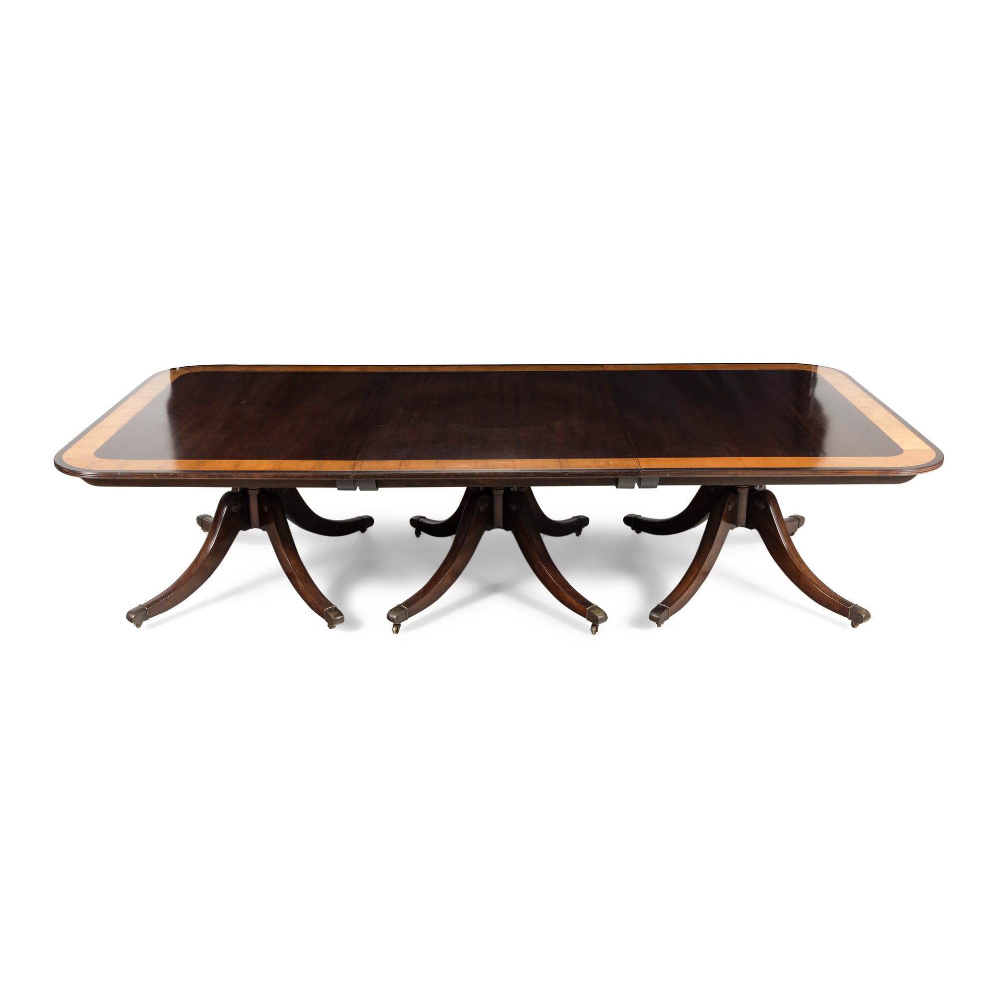 A Regency Style Mahogany and Satinwood Three-Pedestal Dining Table