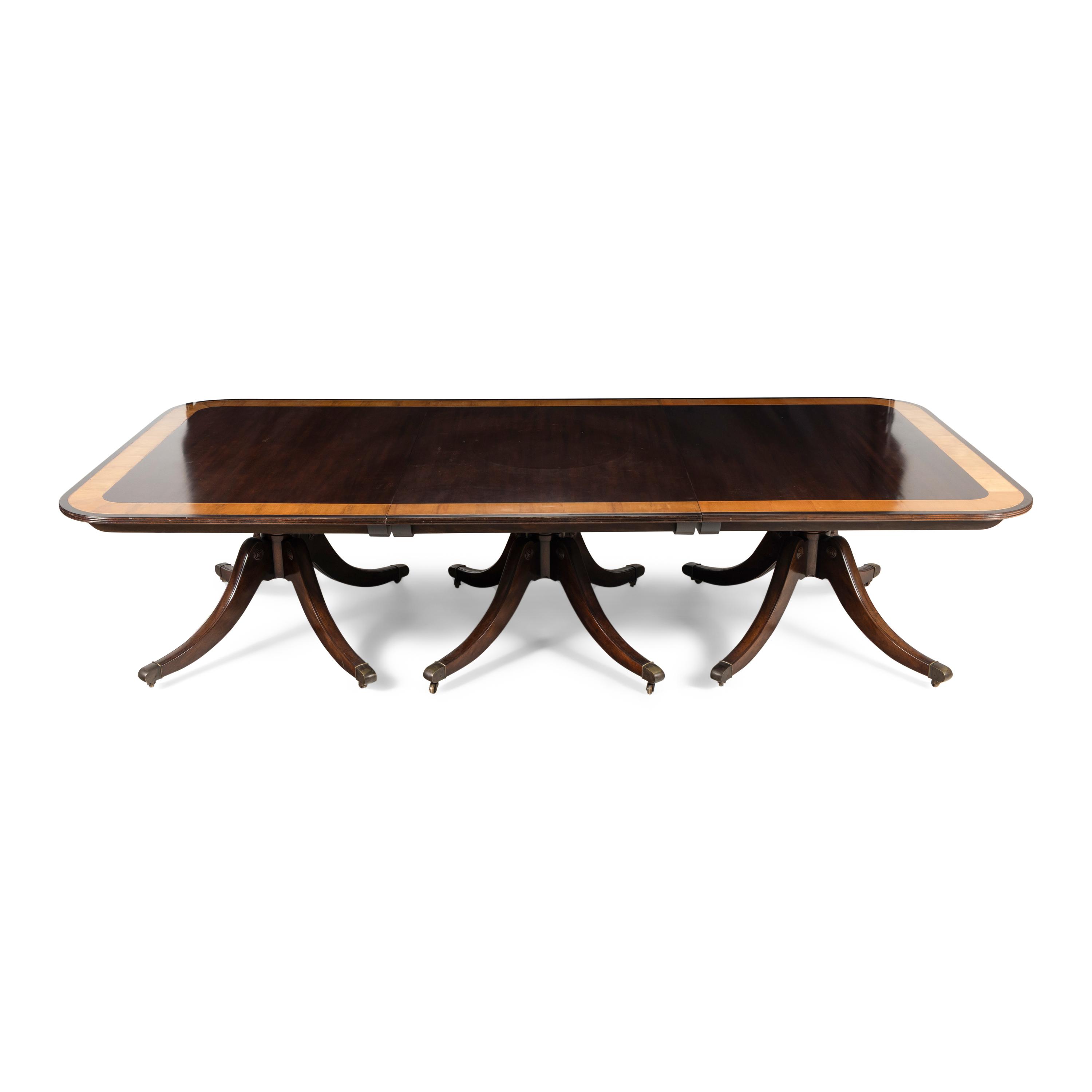 A Regency Style Mahogany and Satinwood Three-Pedestal Dining Table