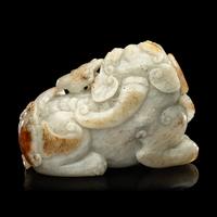 A Chinese Russet and Greyish Celadon Jade Figure of a Recumbent Qilin 青玉麒麟